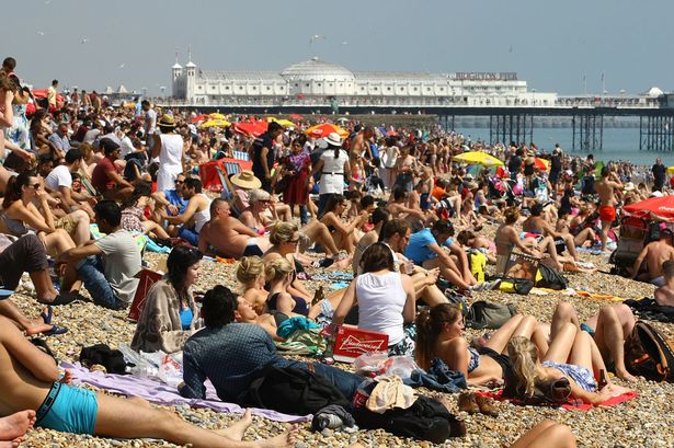 People-enjoy-the-sunshine-on-Brighton-Beach